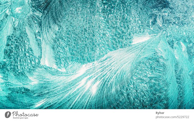 Blue Frosty Glass Ice Background, Natural Beautiful Snowflakes Frost Ice Pattern. Winter Xmas Christmas Abstract Backdrop, Background Or Texture. Turquoise Blue Colour.