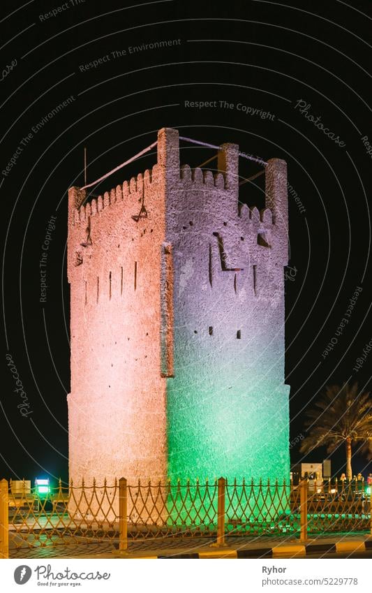 Ajman, United Arab Emirates. Ancient Old Stone AlMurabbaa Watchtower Of Ajman. Famous Landmark in night time traditional UAE travel house architecture urban