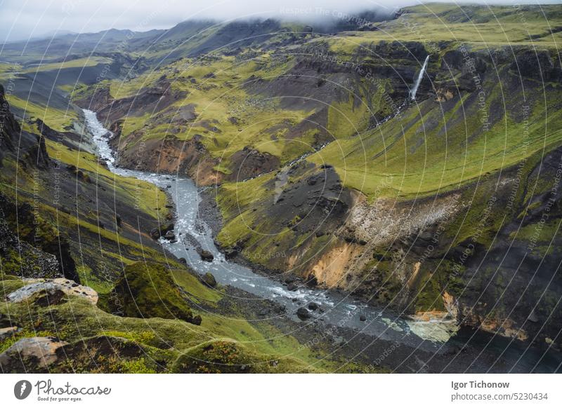 Iceland landscape of highland valley and river Fossa with blue water stream and green hills and moss covered cliffs. South Iceland iceland haifoss summer sky