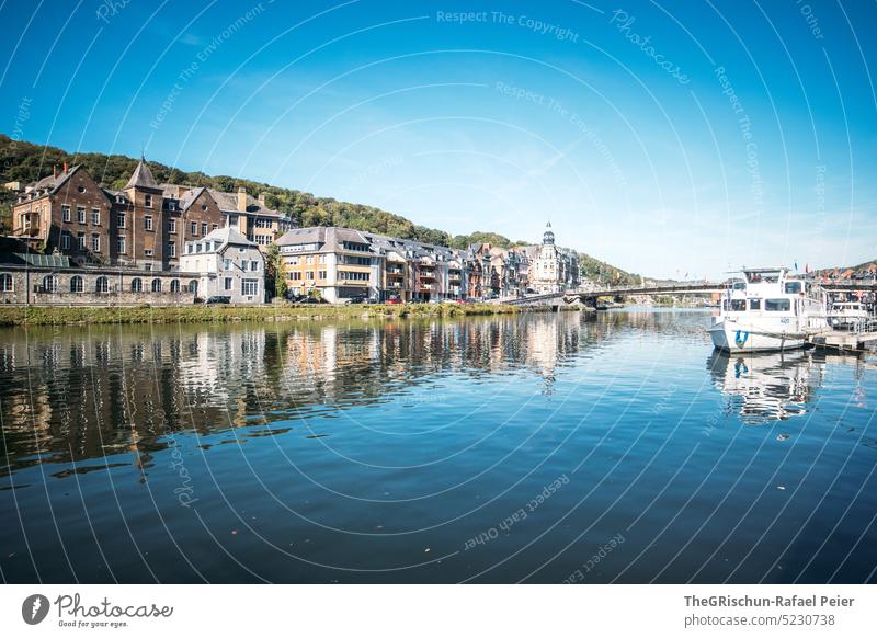 Building on river against blue sky dinant Belgium Architecture Tourism River Forest Water River bank Town Landmark cityscape Vacation & Travel Sky travel