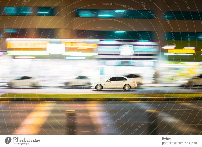 Speeding White Car Fast Driving In City Street. Motion Blur Background car city transport road speed street Emirates UAE United Arab Emirates auto automobile