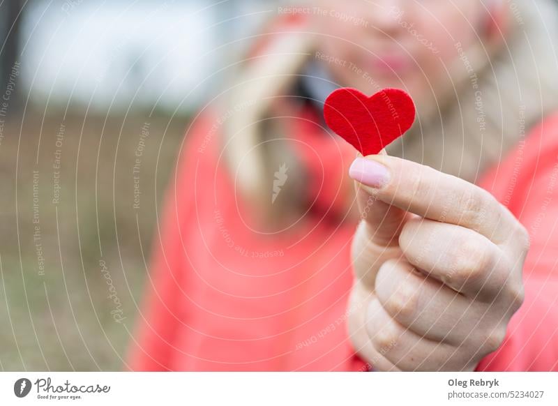 Heart in the girl's hand person red palm day concept love woman female heart gift romantic health heart shape valentine palm of hand love - emotion happiness