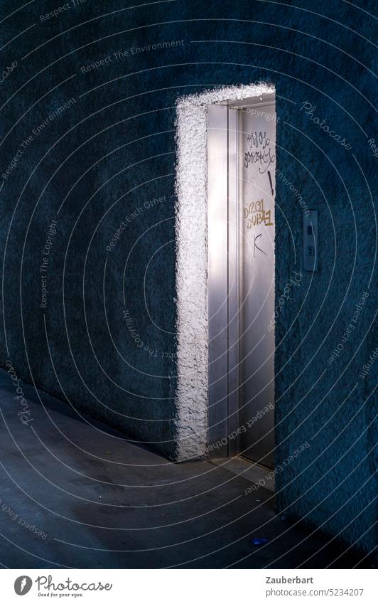 Lonely door of elevator, steel door, lit in gloomy hallway Elevator somber Light Steel Concrete Eerie Dark Low-key peril Fear Dangerous Creepy Shadow