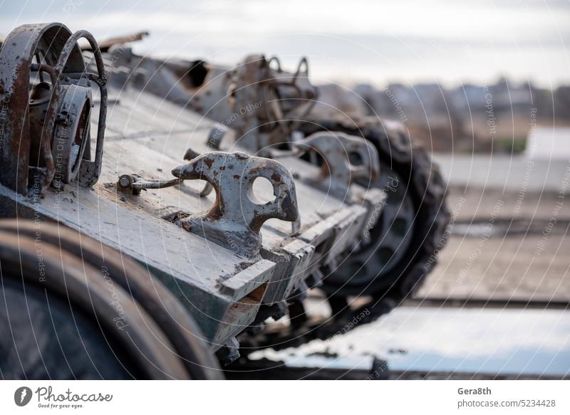 damaged military tank on a city street in Ukraine Donetsk Kherson Lugansk Mariupol Russia Zaporozhye abandon abandoned armor attack bakhmut blown up bombardment