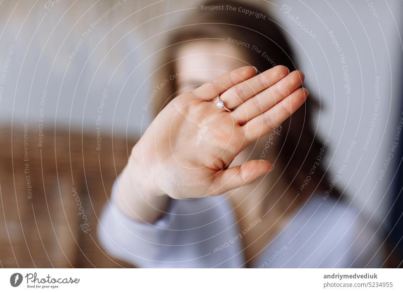 young woman shows a ring with diamond. The girl shows an engagement ring on her finger. she said yes. selective focus on hand. showing wedding female happy