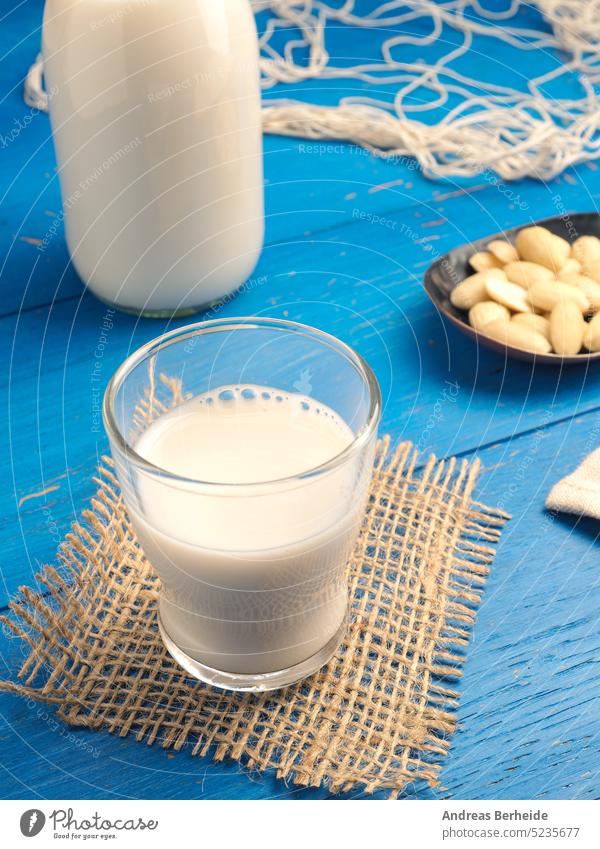 Glass of a tasty organic almond drink glass proteins bottle healthcare alternative almond milk morning wood beverage vegetarian calcium natural vegan food