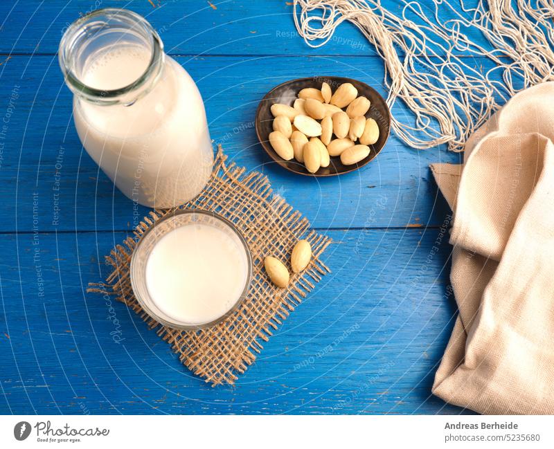 Glass of a tasty organic almond drink glass proteins bottle healthcare alternative almond milk morning wood beverage vegetarian calcium natural vegan food