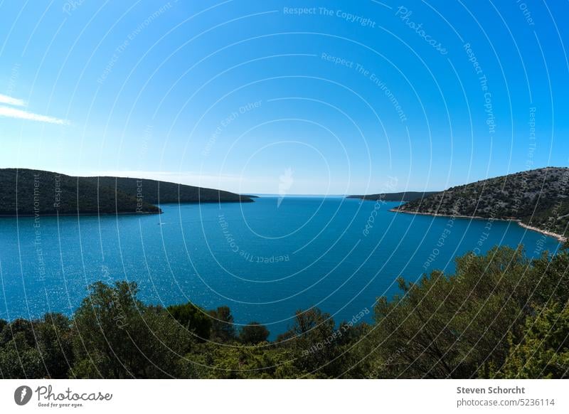 View from a cliff into a bay with blue water Water Landscape Ocean Blue coast Nature Sky blue sea Blue sky Horizon Vacation & Travel Relaxation Beach Deserted