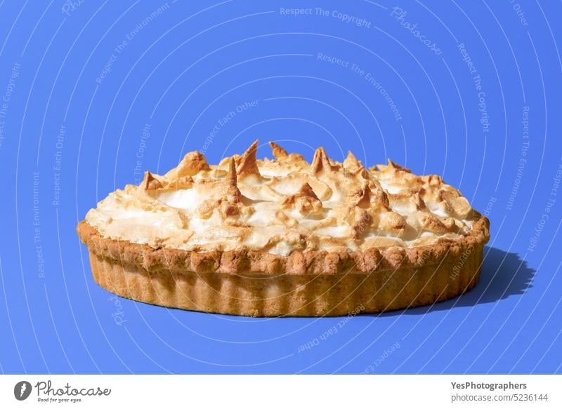 Lemon meringue pie isolated on a blue background. Homemade lemon tart. baked bright cake citrus close-up color confectionary cream crust cuisine custard