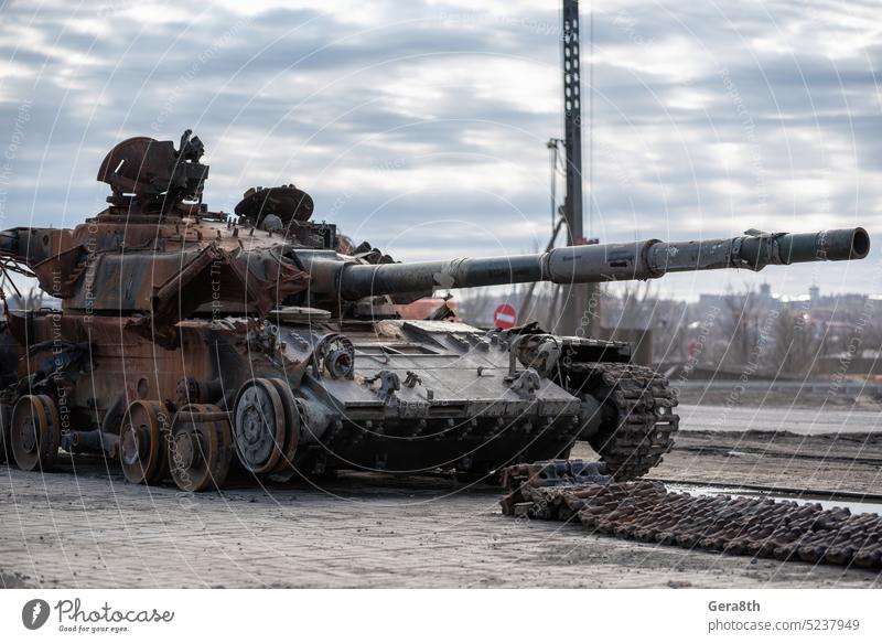 damaged military tank on a city street in Ukraine Donetsk Kherson Lugansk Mariupol Russia Zaporozhye abandon abandoned armor attack bakhmut blown up bombardment