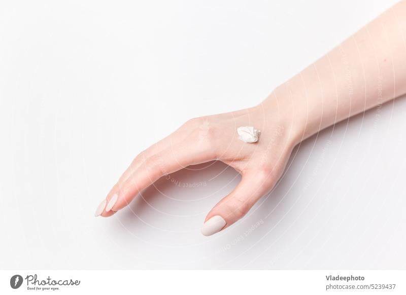 Closeup view of Woman Hands Applying Hand Cream. on White Background. Beauty shot beauty woman hand cream applying closeup hands manicure skin female beautiful