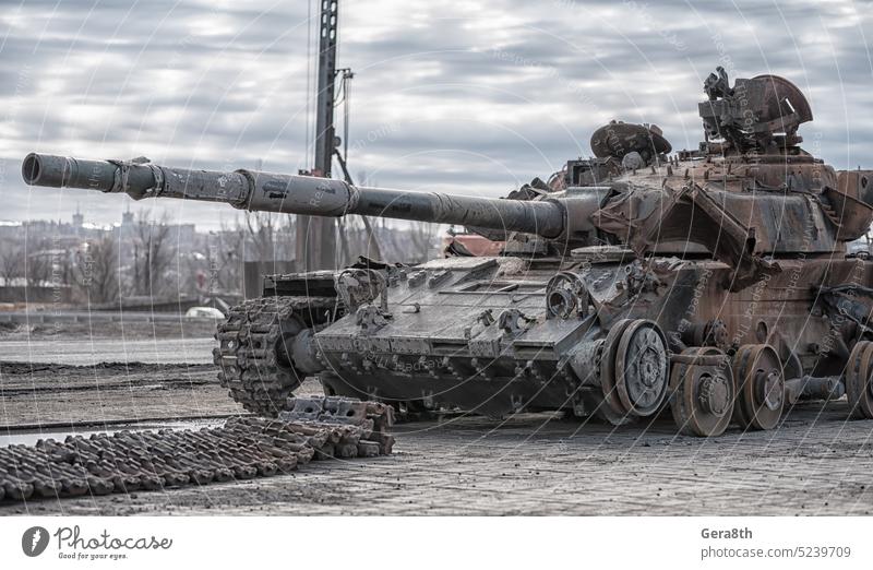 damaged military tank on a city street in Ukraine Donetsk Kherson Lugansk Mariupol Russia Zaporozhye abandon abandoned armor attack bakhmut blown up bombardment