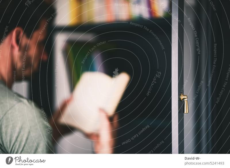 Man reading a book in front of a bookshelf Bookshelf Reading Education Library Literature Know Reading matter Hand Anonymous Academic studies Science & Research