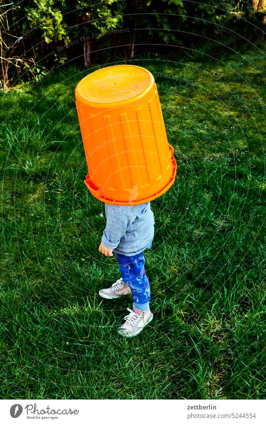 Hidden child Child game Hiding place covert game of hide-and-seek Garden Meadow Stand Anonymous Bucket Headwear Search Blind Orientation Disorientated