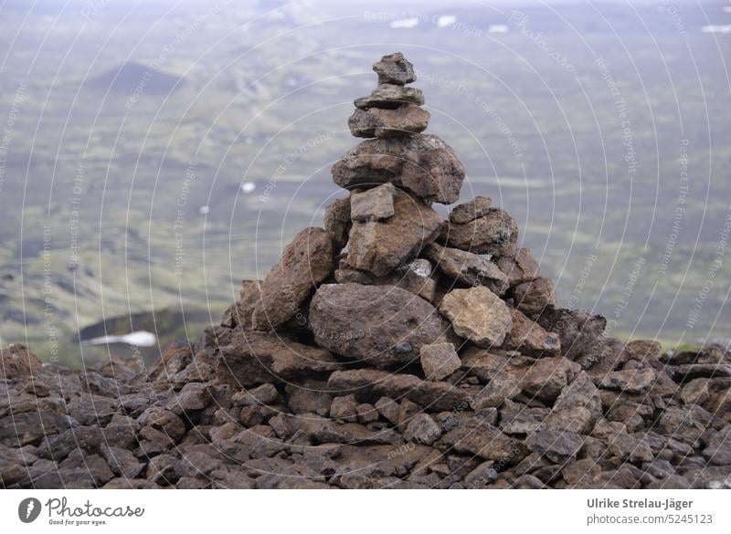 Iceland | cone of volcanic rock with chain of volcanoes in background Volcanic volcanic landscape Skittle bunked piled up stone volcano chain Landscape