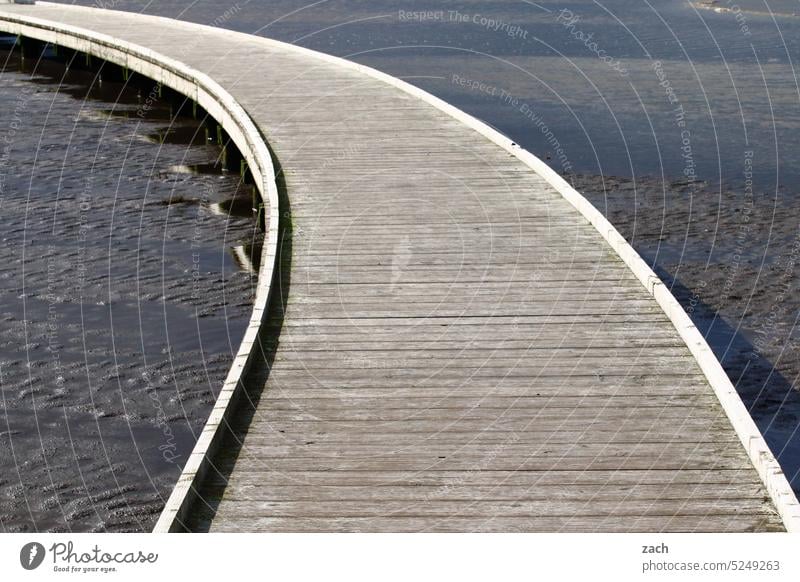 next left Curve Ocean Mud flats watt North Sea Footbridge wooden bridge coast Water Low tide Nature North Sea coast Tide