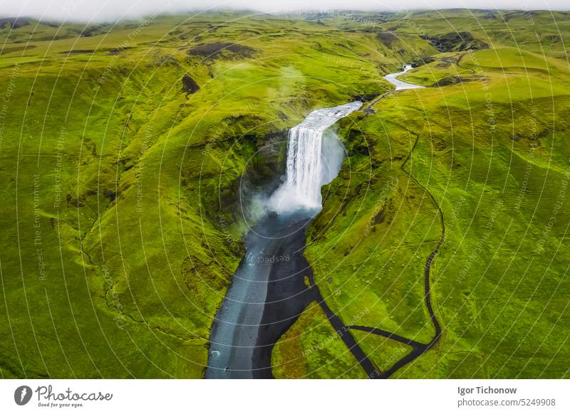 Aerial drone view of Skogafoss waterfall in Iceland, one of the most famous tourist visited attraction and landmark landscape aerial beautiful iceland south