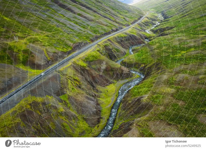 Aerial view of remote mountain road and river in the valley at north in Iceland, summertime iceland aerial green landscape nature outdoor sky travel europe