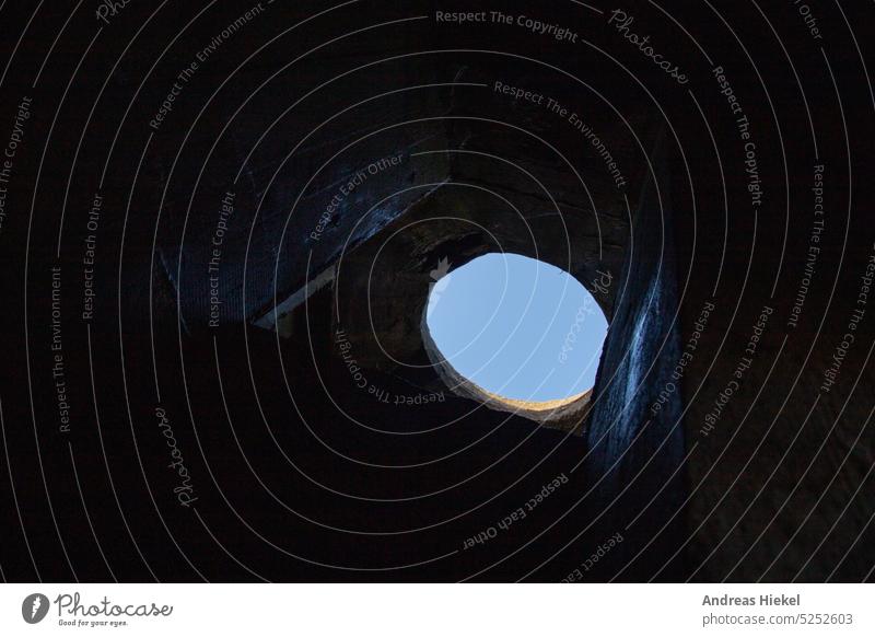 Hole in the prison ceiling Freedom Hollow Dark jail cell penned Sky Exit route outlook Dramatic Dugout Futile Captured Escape Escape route Flee Concrete