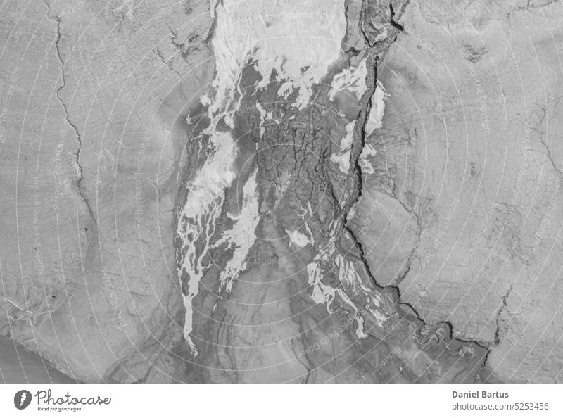 The structure of cracked wet earth at the bottom of the lake, creating irregular patterns, structure, background. Amazing shapes created by nature at the bottom of a lake where there is no water