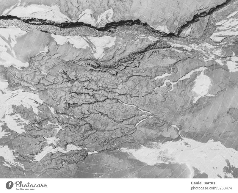 The structure of cracked wet earth at the bottom of the lake, creating irregular patterns, structure, background. Amazing shapes created by nature at the bottom of a lake where there is no water