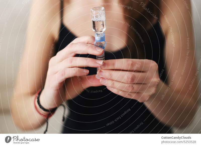 Woman filling up the reservoir of her insulin pump with insulin Filling up Reservoir Insulin pump Type 1 diabetes Diabetes care Medical equipment