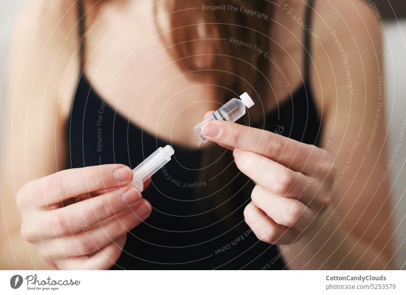 Woman holding a reservoir just filled with insulin for her insulin pump Holding Reservoir Filled with insulin Insulin pump Type 1 diabetes Diabetes care