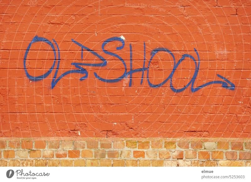 OLDSHOOL is written in blue on a red brick wall oldshool Oldschool English old school Classic nostalgically Blog Archaic Graffiti as before well-tried