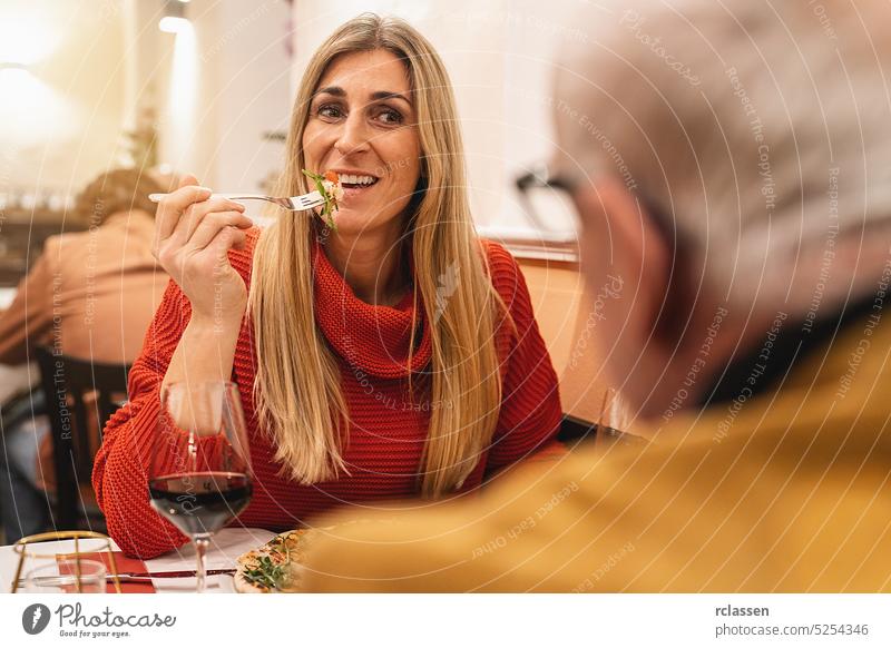 Couple at rendevouz eating pizza with a fork and drinking wine in a italian restaurant margherita couple rendezvous slice cheese basil london new york taste