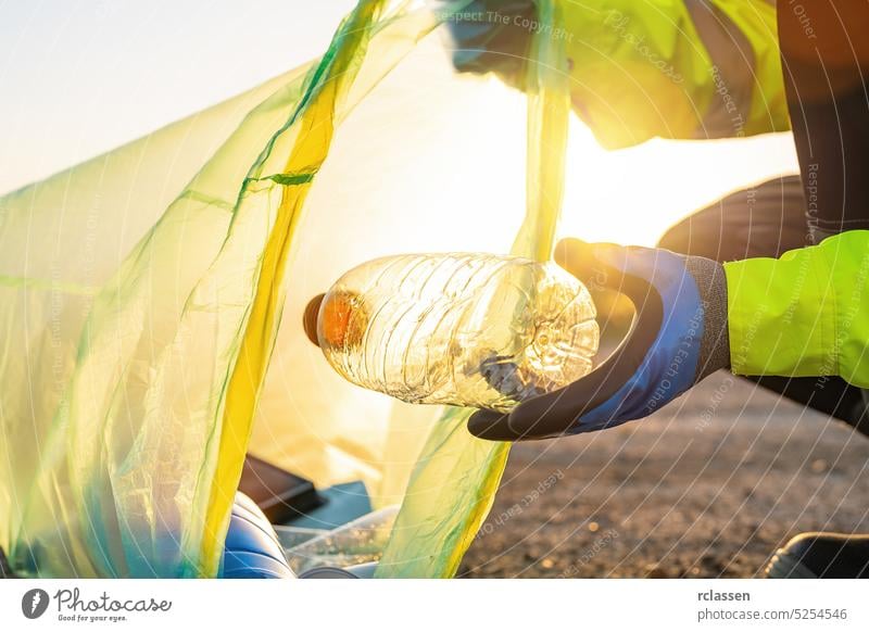 volunteer with garbage bag cleaning area in park, People and ecology. Volunteer concept image activist bin bottle conservation dump container