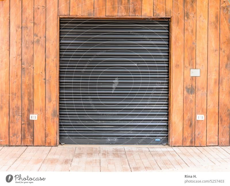 Rolling gate on a wooden facade Nature Rolling shutters Holzhausen Wooden facade Building outside door Goal roller shutter