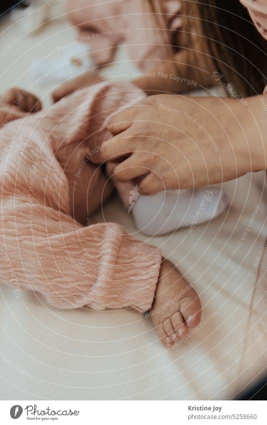 Putting socks on baby feet by mother Baby Feet putting socks Mother Toes Human being Parts of body