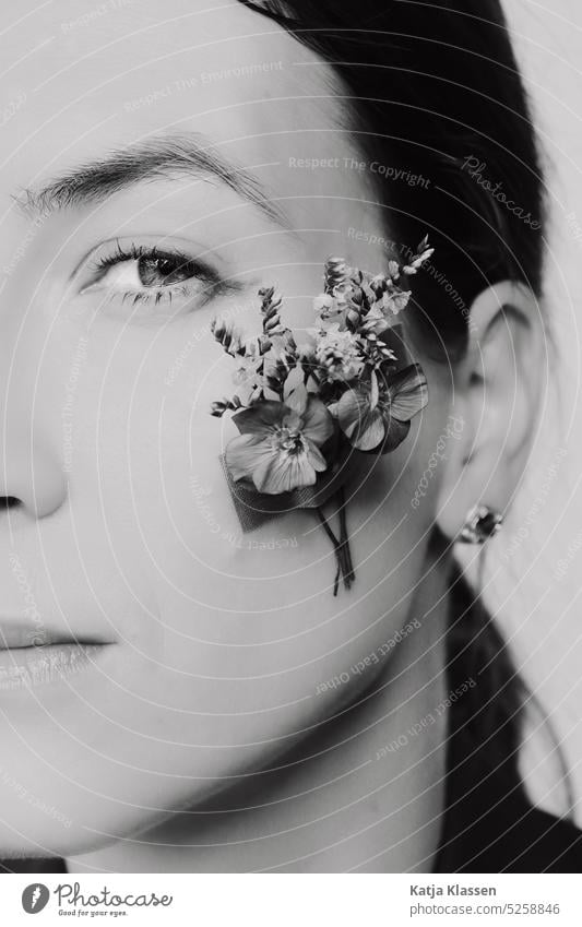 Portrait of young woman with flowers on cheek portrait Young woman Flowers on the cheek black-and-white Eyes Cheek Woman eyebrown Looking Lips Eyelash pretty