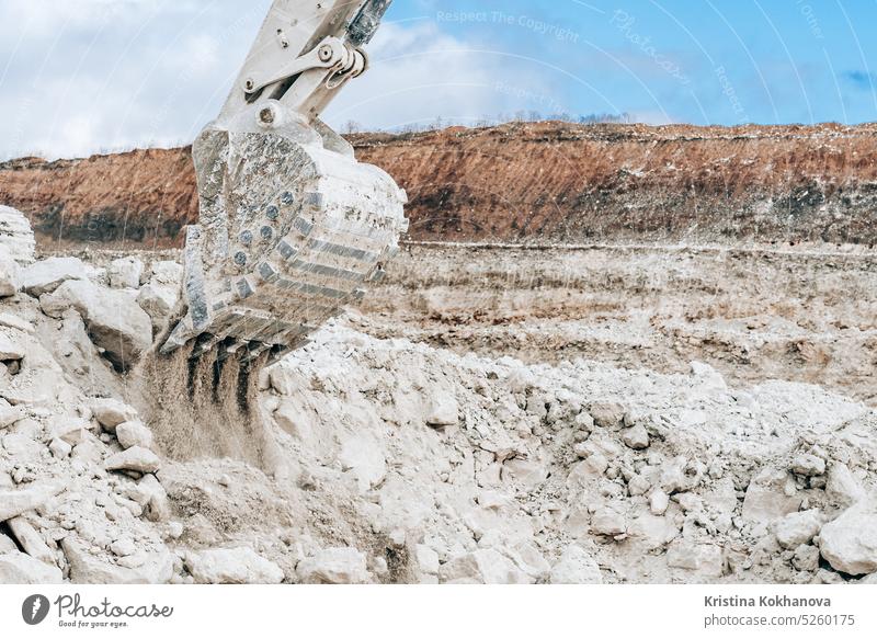 Close-up view of excavator large bucket on construction site or quarry. Mining heavy machinery details. Earthmoving, excavations, digging on soils. industry