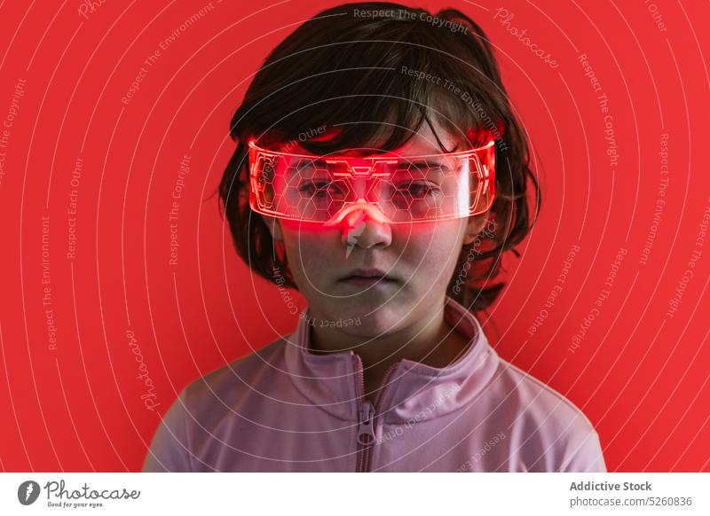 Girl in glowing futuristic glasses girl neon illuminate ornament cyberpunk portrait color bright kid dark hair goggles individuality jacket vivid modern child