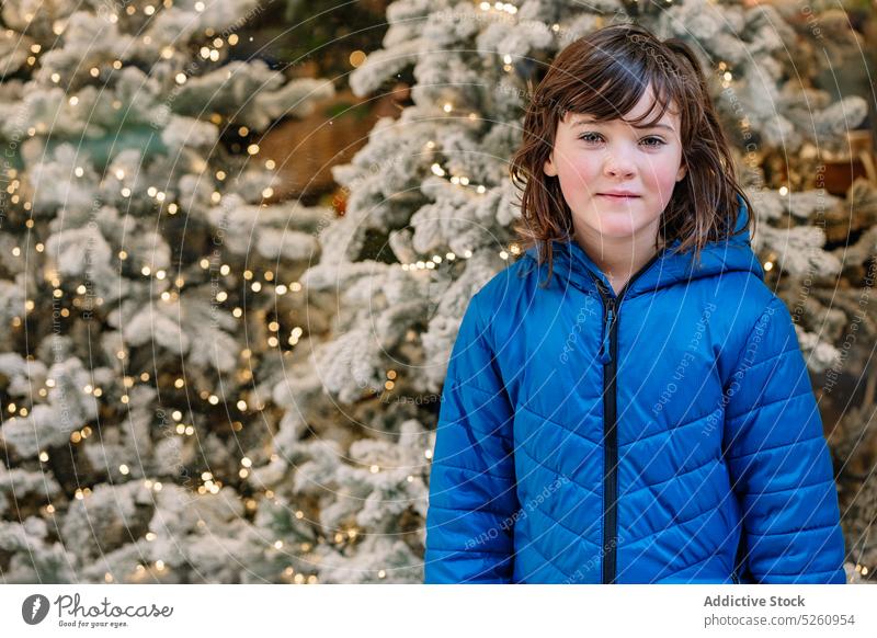 Girl near decorated Christmas trees girl christmas tree street outerwear holiday fairy light festive winter portrait donostia san sebastian spain decoration