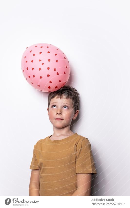 Boy playing with pink balloon boy balance heart love saint valentine day inflatable holiday symbol cute child shape romantic playful adorable innocent festive