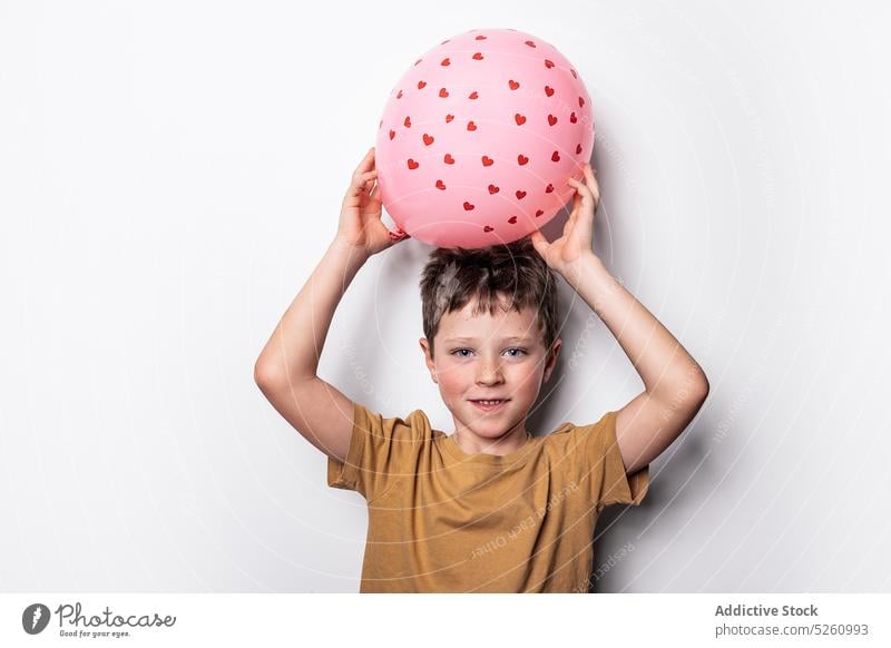 Boy playing with pink balloon boy heart love saint valentine day inflatable holiday symbol cute child shape romantic playful adorable innocent festive celebrate