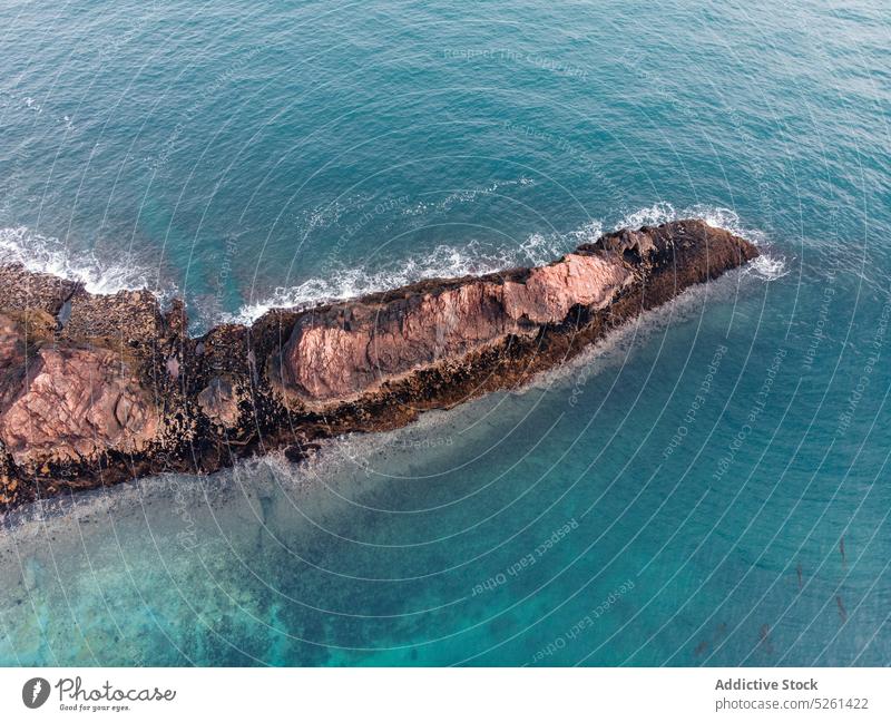 Picturesque view of headland surrounded by sea scenery seascape rough cliff rocky nature environment formation ripple blue scenic water seashore coast ocean