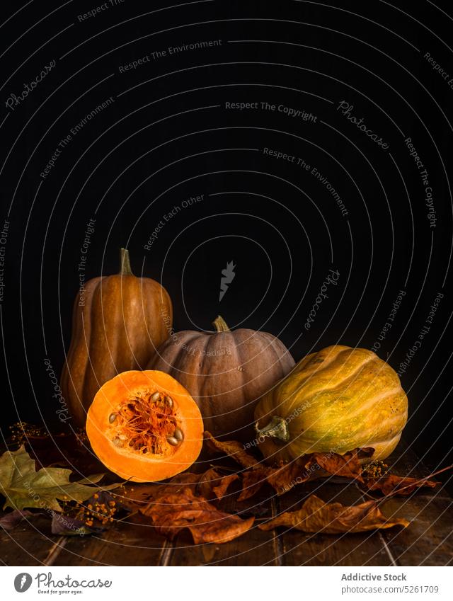 Pumpkins and dry leaves on wooden table autumn pumpkin harvest leaf orange maple ripe decoration design season thanksgiving vegetable fall organic october