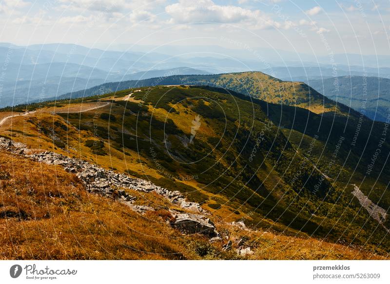 Mountain landscape. Scenic view of mountain peaks, slopes, hills and valleys covered with grass and trees. Panoramic view. Natural scenery nature trip vacation