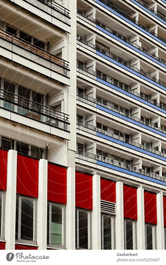 Facade of a skyscraper in blue and red in Berlin High-rise Apartment Building Blue Red Balconies dwell Downtown living space people Population