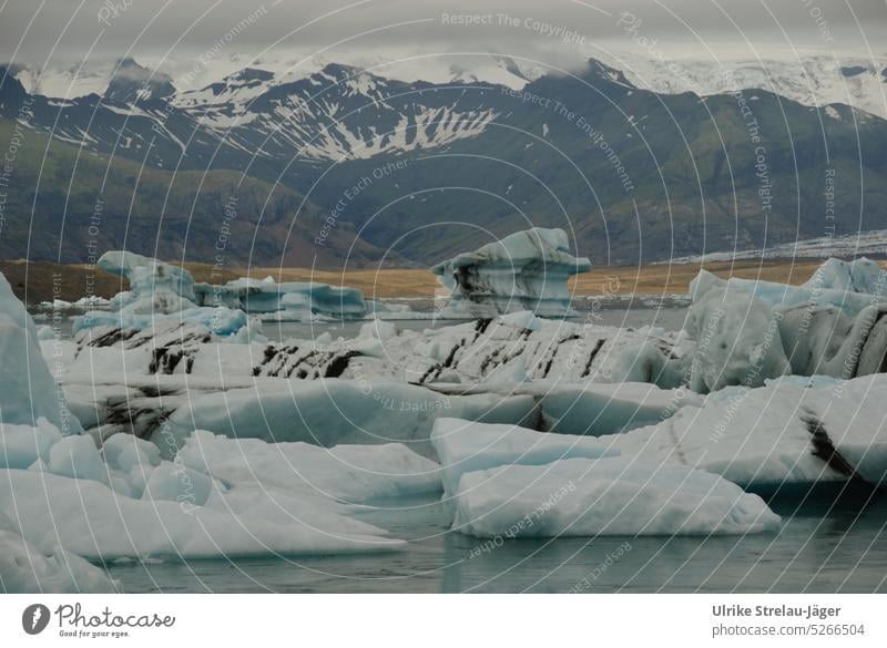 Joekulsarlon glacier lagoon with floating icebergs and mountain landscape Iceberg Icebergs Glacial melt Glacier ice Ice formations Climate change Blue White