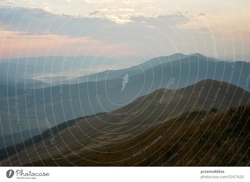 Mountain landscape. Scenic view of mountain peaks, slopes, hills and valleys covered with foggy slopes and valleys. Panoramic view nature trip vacation panorama