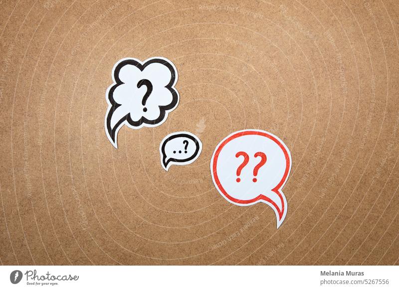 Question marks in speech bubbles. Paper shape of bubble with hand drawn interrogation points. Question concept, important information, dispute, hesitation concept.