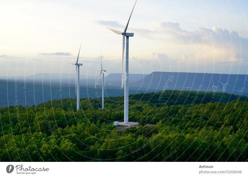 Wind energy. Wind power. Sustainable, renewable energy. Wind turbines generate electricity. Windmill farm on mountain with sunset sky. Green technology. Renewable resource. Sustainable development.