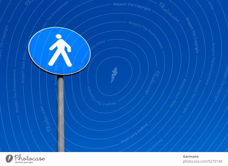 Sign pedestrian crossing Europe blue bright careful caution city color copy copyspace crosswalk daylight drive feet figure information leg man nobody object