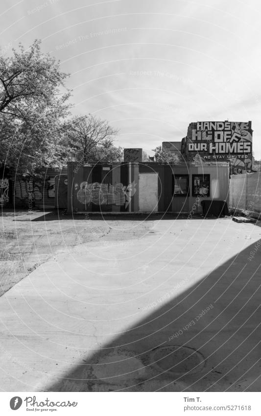 Hands off our Homes Berlin b/w Spring Graffiti Black & white photo Exterior shot Town Deserted Day Downtown Capital city Architecture Manmade structures