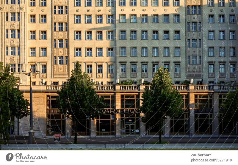 Bookstore and golden facade of a "workers' palace" in the evening sun in Karl-Marx-Allee Facade Evening sun bookshop Charles Marx Workers Palace stalin