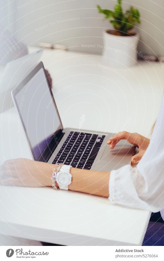 Unrecognizable woman Typing on Her Laptop laptop business computer typing pc keyboard job work keypad workplace using technology close-up hand closeup office